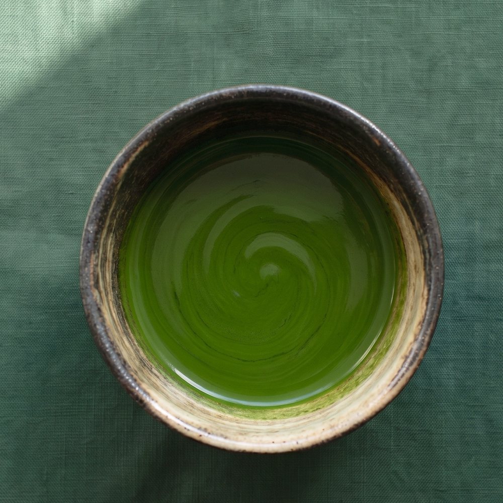 Koicha — thick whisked ceremonial matcha in a rustic chawan