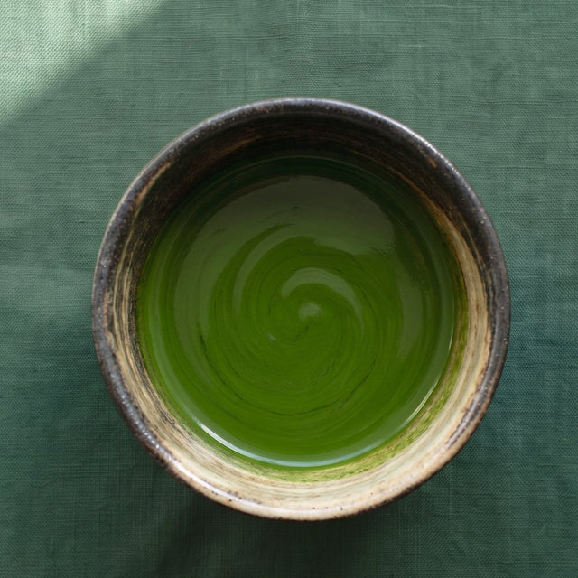 Koicha — thick whisked ceremonial matcha in a rustic chawan