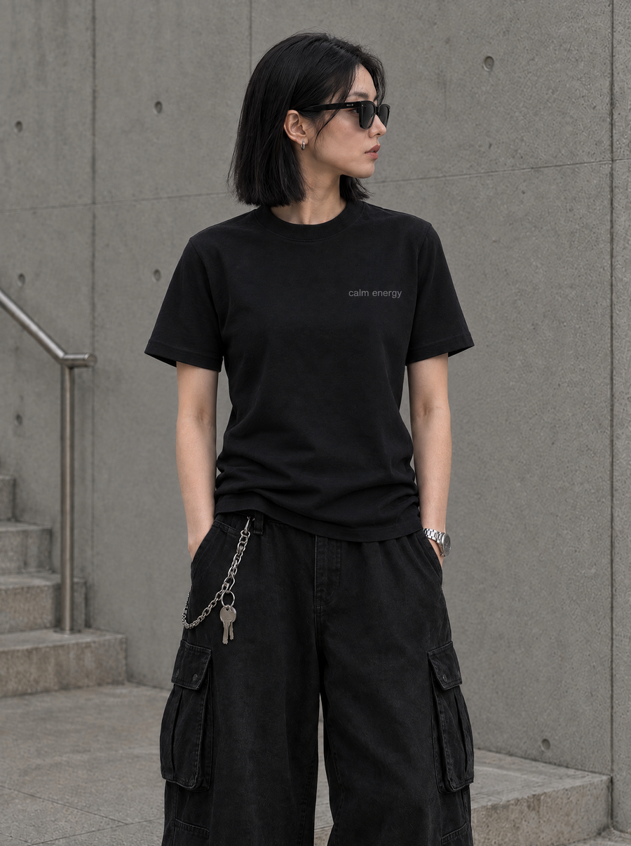 Front view of a model wearing the black MatchaXWorld Calm Energy T-Shirt