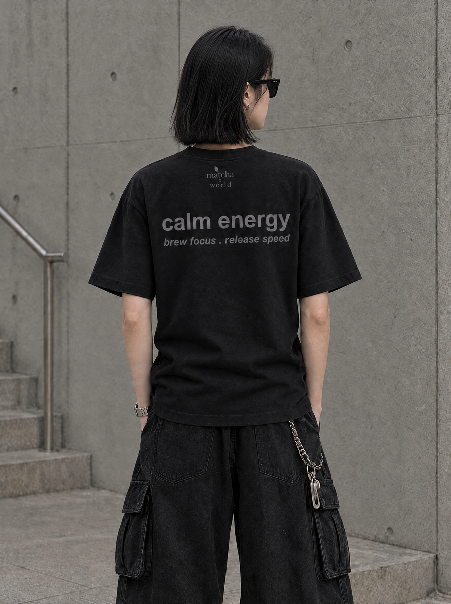 Back view of the black MatchaXWorld T-Shirt with calm energy and brew focus. release speed lettering