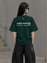 Back view of the green MatchaXWorld Calm Energy women's T-shirt with white statement lettering